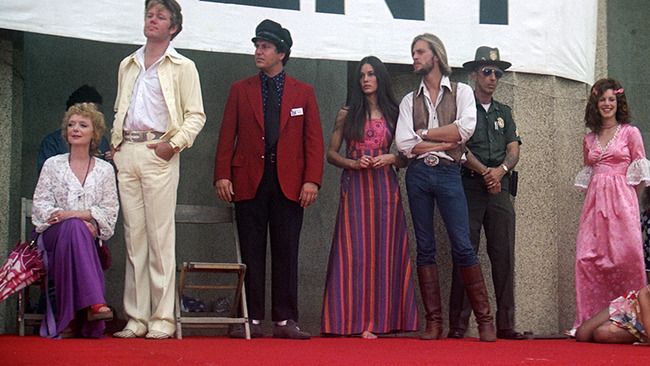 An assortment of performers, dressed in amazing '70s outfits, stand onstage during the final concert at the end of Robert Altman's 1975 film Nashville.