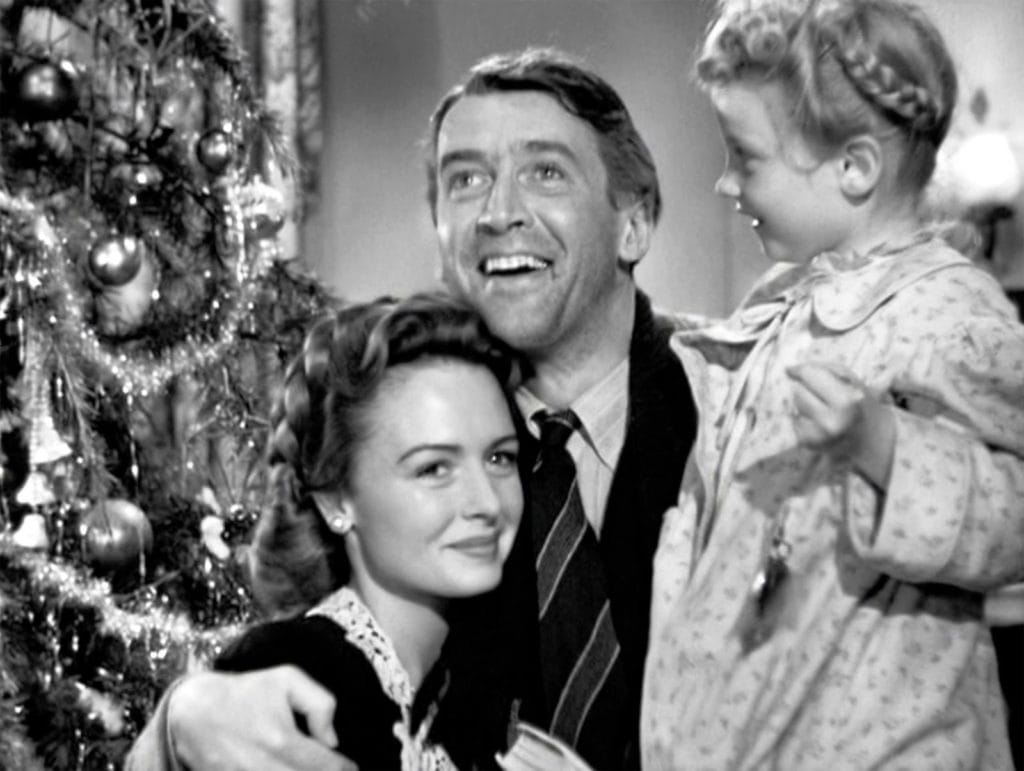 George clutches his wife and daughter to him in the film's emotional climax. He smiles heavenward, toward his guardian angel.