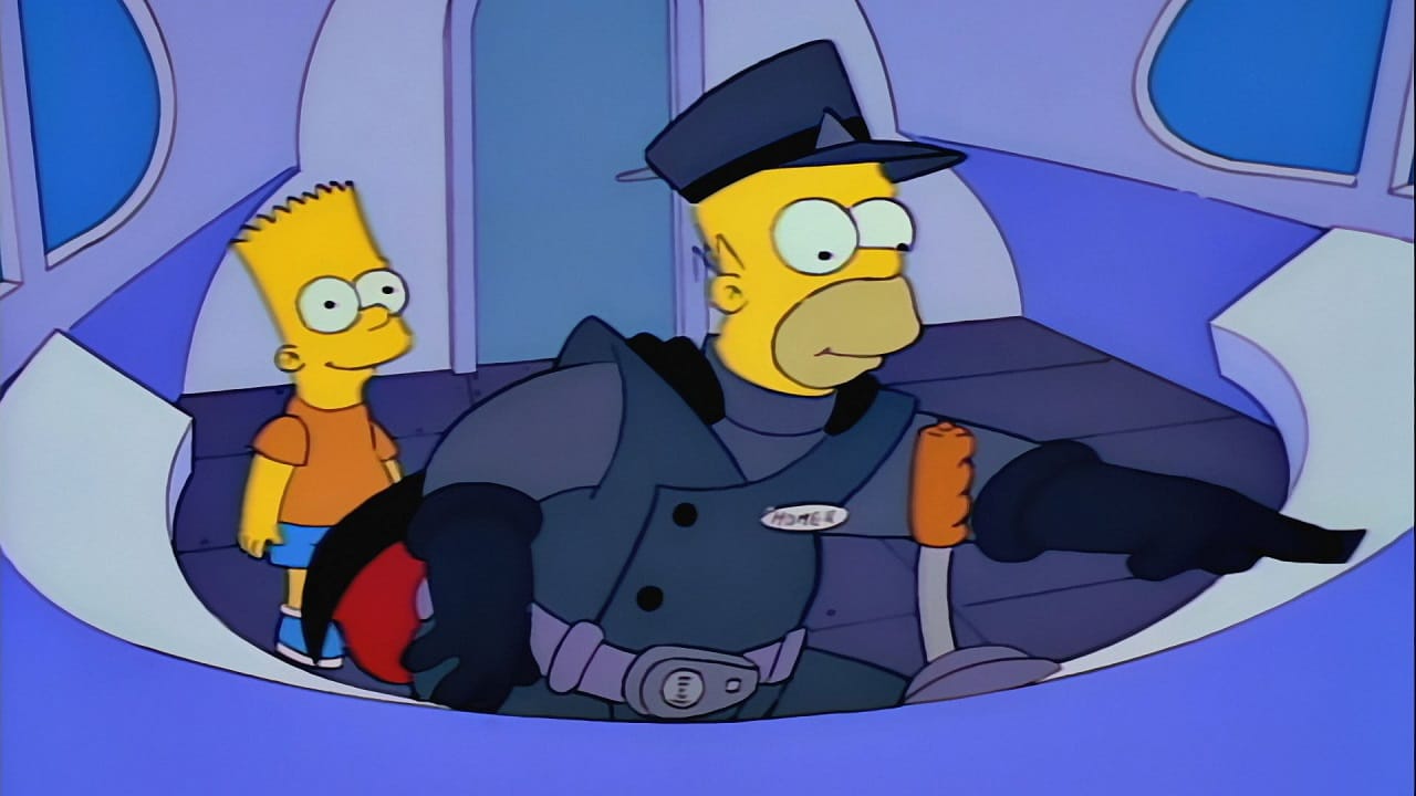 Homer sits behind the controls of the monorail as Bart looks on with pride.