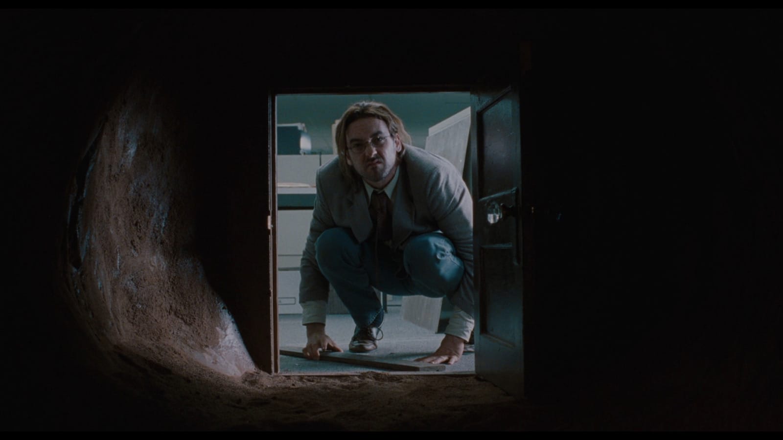 John Cusack stares down a long, weird tunnel in Being John Malkovich.