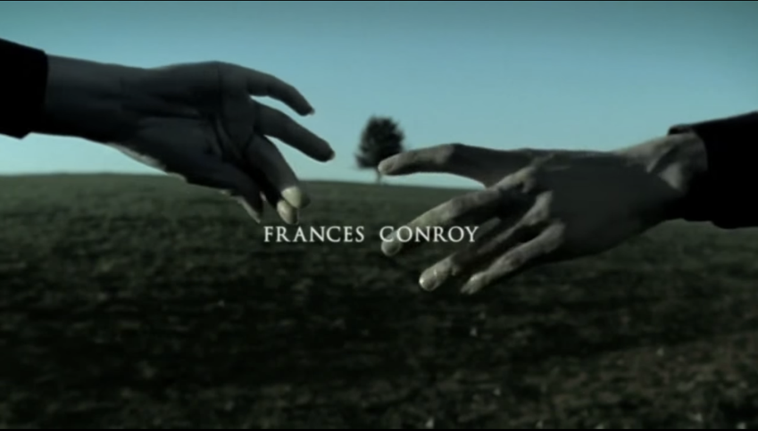 Two hands part in front of a single tree. The name "Frances Conroy" is on screen.