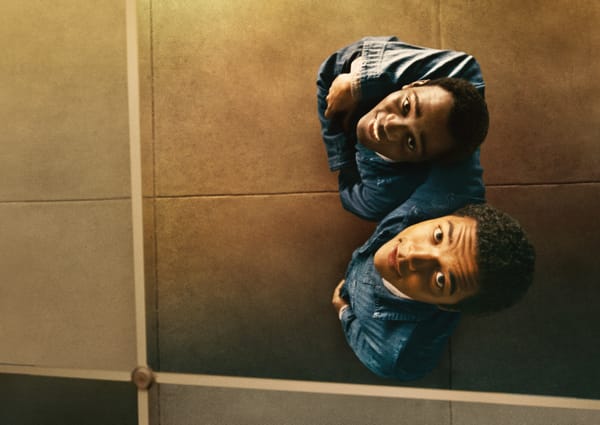 The two protagonists of Nickel Boys look up at their reflection, smiling as they look at themselves.