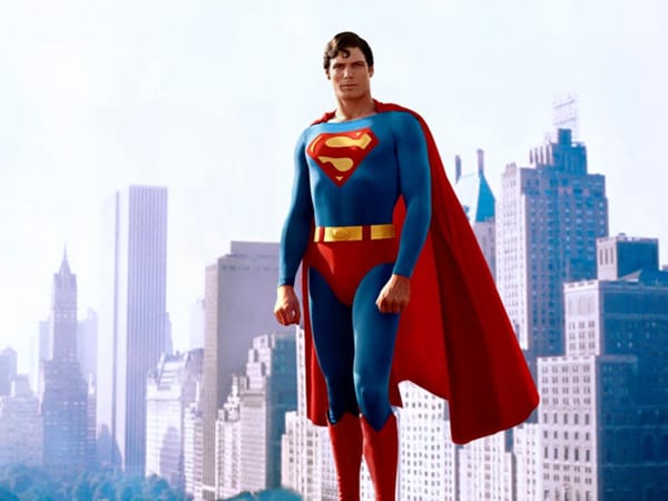 Christopher Reeve in full Superman suit -- complete with red cape -- floats in front of the New York skyline.