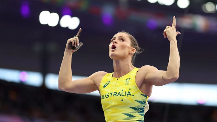 Nina Kennedy, the Australian who won the women's pole vault, celebrates her victory by thrusting her hands in the air.