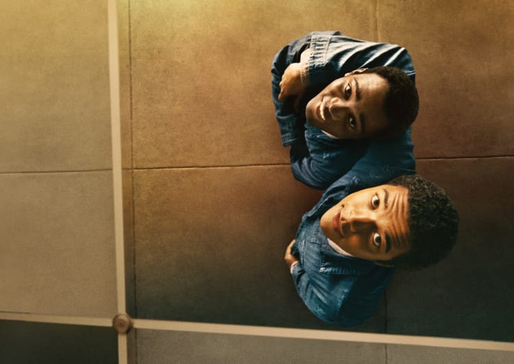 The two protagonists of Nickel Boys look up at their reflection, smiling as they look at themselves.