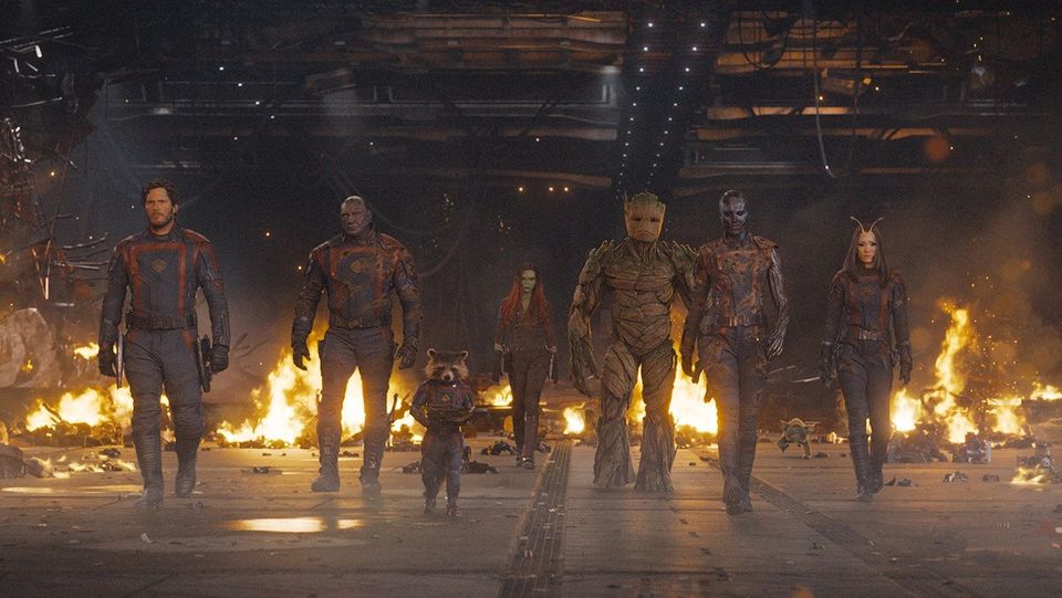 The Guardians of the Galaxy -- Star Lord, Drax, Rocket, Gamora, Groot, Nebula, and Mantis -- stride toward camera.