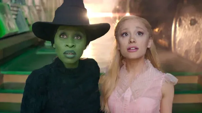 Cynthia Erivo, made up in all green, stars as Elphaba, and Ariana Grande (in all pink) plays Galinda.