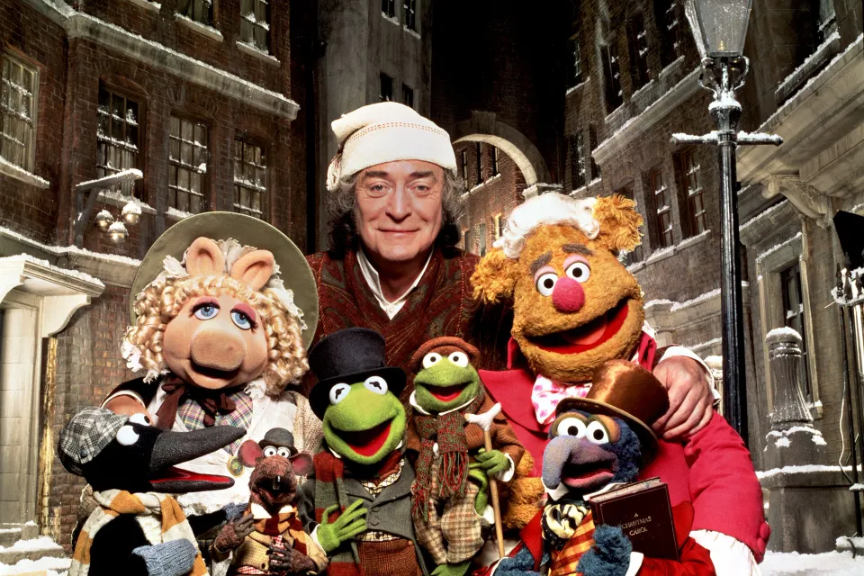 Michael Caine (in nightcap) joins several Muppets on the Muppet Christmas Carol set.