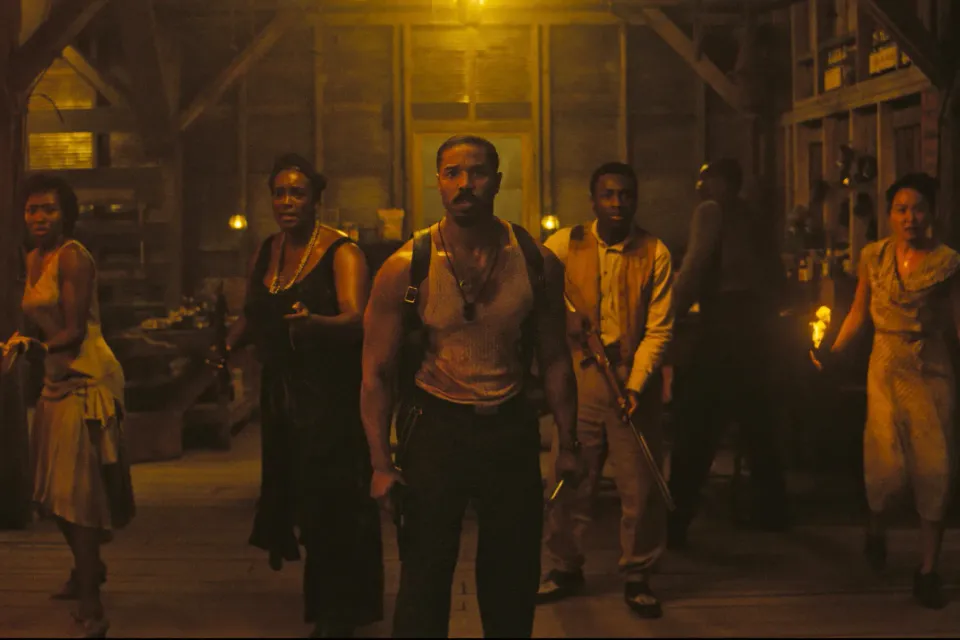 The characters of Sinners arm themselves and face the door of the juke joint as they wait for monsters to pour in.
