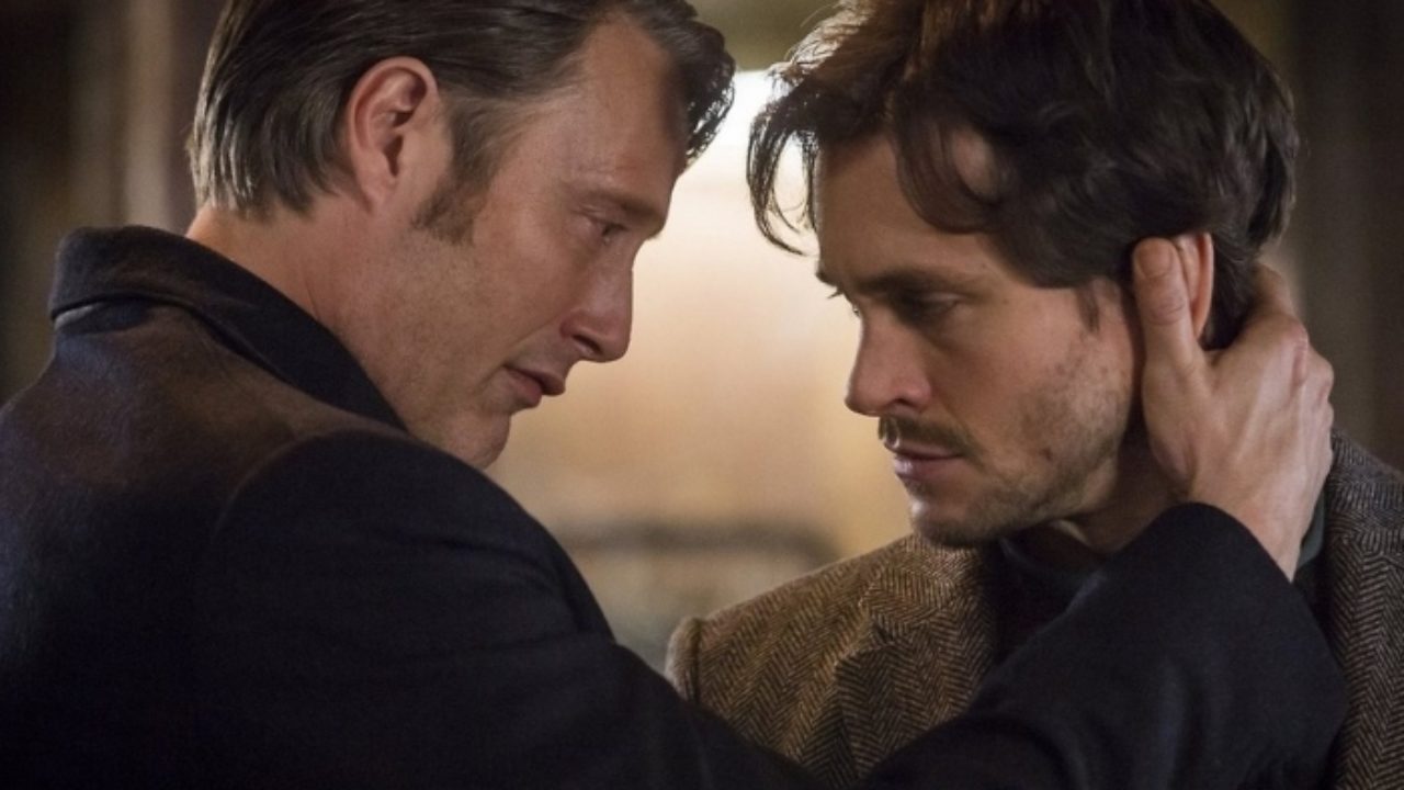 Hannibal leans in close to Will, his hand on the side of Will's face. It's very intimate.
